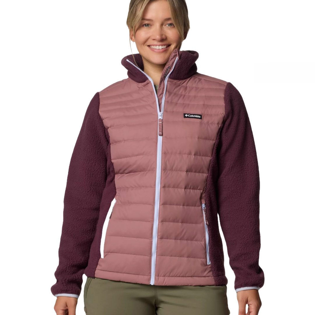 Columbia jacket with a quilted pink front and dark purple fleece sleeves, featuring a full-length zipper and zippered pockets.