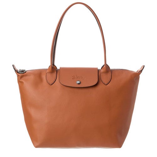 Brown leather tote bag with dual handles, a flap-closure, and a snap button featuring embossed logo detailing.