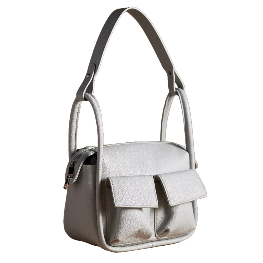 A structured, white leather box bag featuring two front flap pockets, a wide shoulder strap, and side buckles for closure.