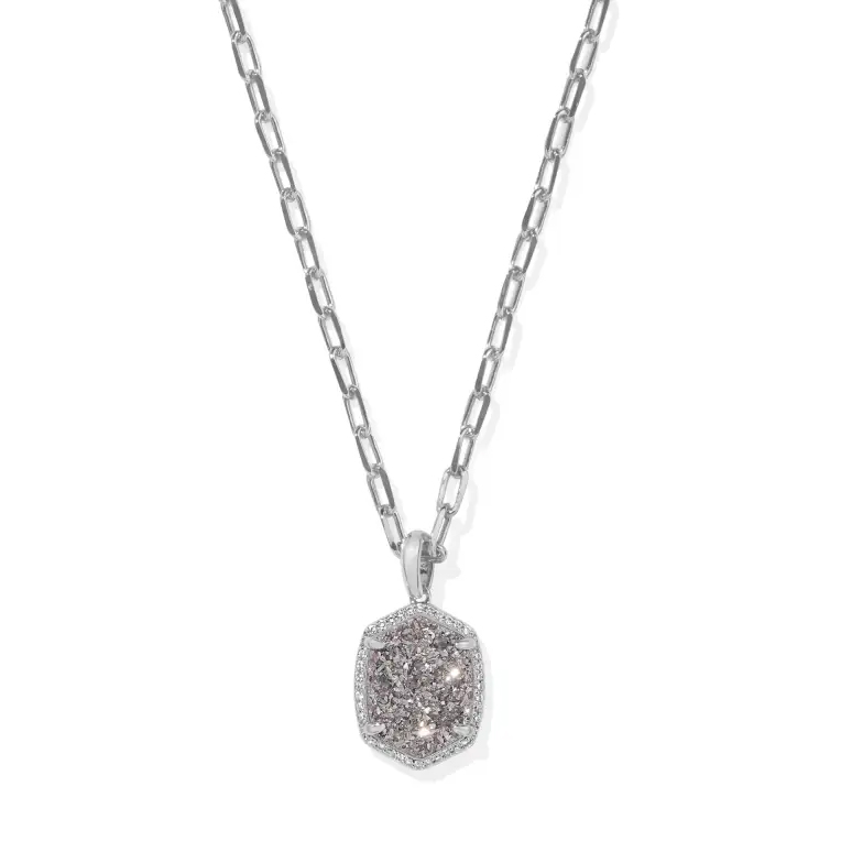 The Kendra Scott Daphne Necklace features a silver chain with an elongated link design and a hexagonal pendant adorned with clustered crystals, providing a subtle yet elegant sparkle.