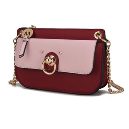 A stylish handbag with a gold chain strap, featuring a burgundy body and a light pink front flap adorned with a gold ring accent and a charm with the letter \“M.\“