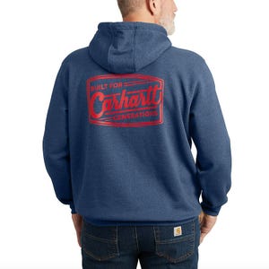 Blue Carhartt hoodie with \“Built for Generations\“ and a Carhartt logo in red on the back. Accompanied by dark blue jeans featuring a Carhartt label on the pocket.