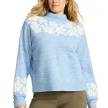 A light blue sweater with white floral patterns along the shoulders and sleeves, featuring a ribbed mock neck and cuffs.
