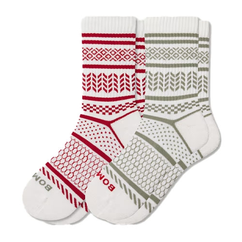 A pair of crew socks with geometric patterns, one in red and white and the other in olive and white. Each sock features brand lettering near the toe.