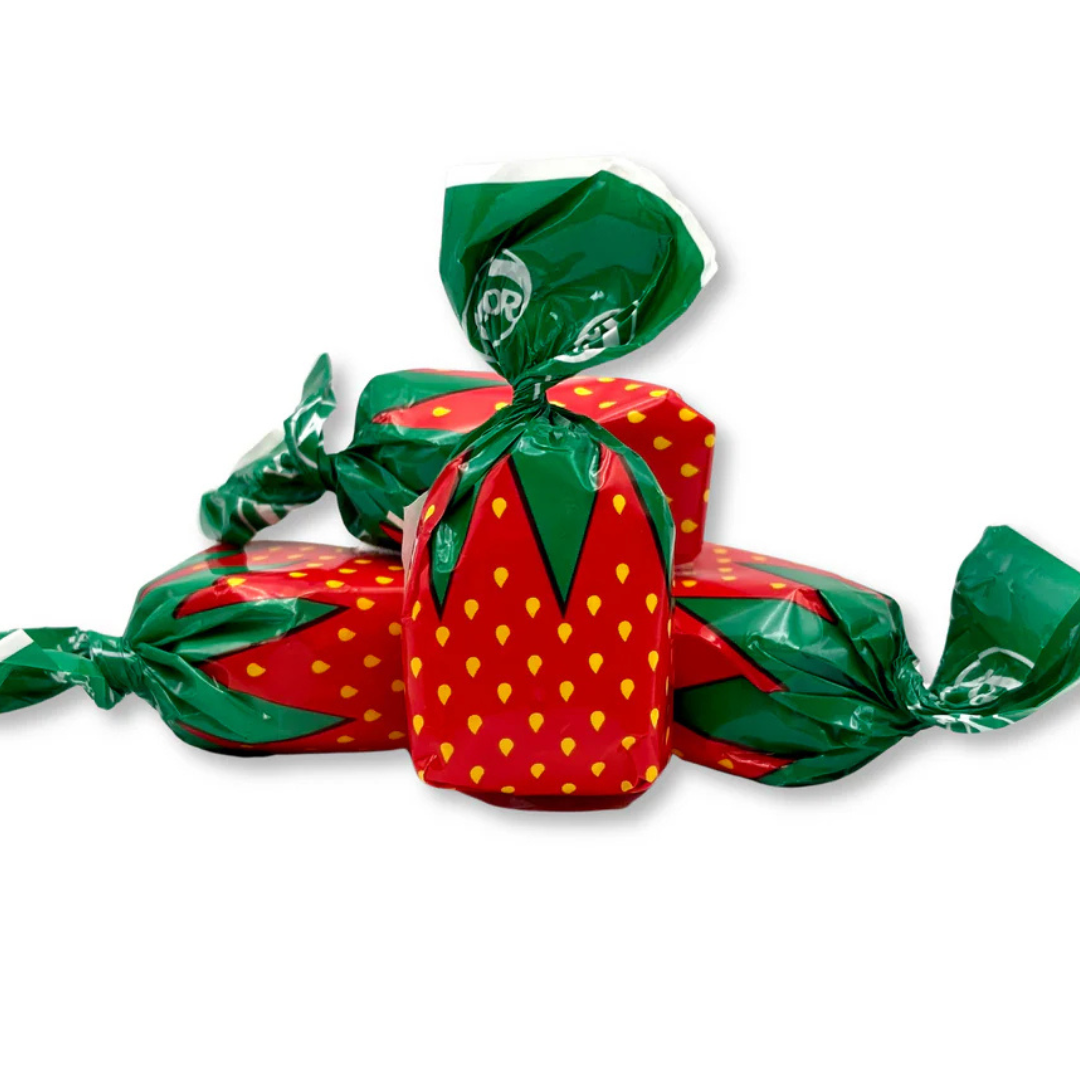 Strawberry-shaped hard candies with green wrappers that resemble strawberry leaves.