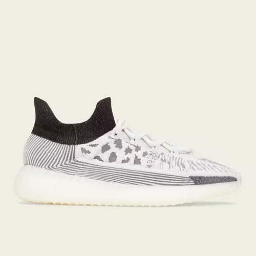 A pair of white and grey patterned knit sneakers with black ankle collars and a translucent sole.