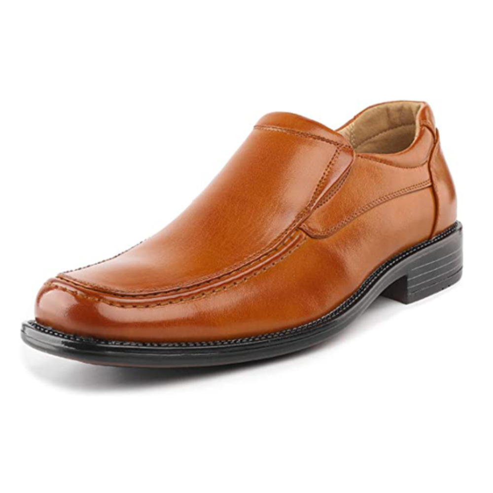 A tan leather slip-on dress shoe with black sole and low heel, featuring sleek stitching and a rounded toe design.