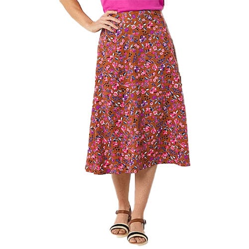A floral-patterned, knee-length brown skirt paired with a pink top and brown sandals.