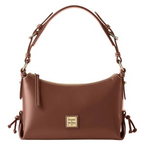 Brown Dooney & Bourke hobo bag with a smooth finish, features a zip closure, adjustable knotted strap, side tassels, and a gold-tone logo plaque.