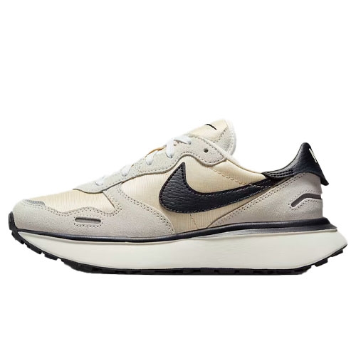 A beige and black Nike sneaker with a retro design, featuring a prominent black Swoosh and a thick white sole.