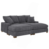 A dark grey corduroy sectional sofa with a low-profile design and wooden legs, featuring multiple cushions for added comfort.