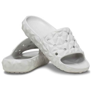 White geometric-patterned slide sandals with open toes, featuring breathable holes and textured soles for comfort and grip.