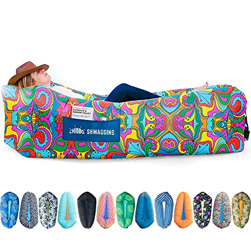 The Chillbo Swaggins Inflatable Couch displays a vibrant, psychedelic paisley design and includes an individual reclining on it with a hat, showcasing various color options below.