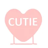 A pink heart-shaped sign featuring the word \“CUTIE.\“