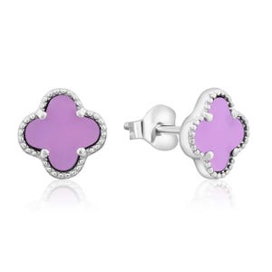Silver Clover Earrings feature a four-leaf clover design with a purple inlay, framed by a dotted silver border. They are stud earrings with a secure post and butterfly clutch backing.
