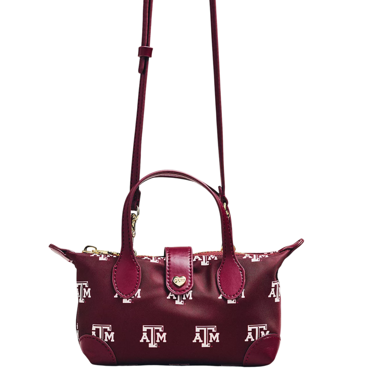 A maroon shoulder bag features the Texas A&M logo pattern, with dual handles, a long strap, and a gold heart charm on the closure.