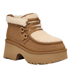 A sheepskin platform boot with a sturdy rubber sole, featuring brown suede, cream shearling trim, and lace-up details.