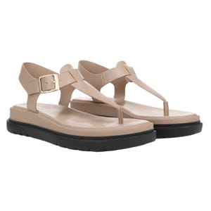 Beige cushioned sandals with black soles, featuring a thong strap design, adjustable ankle buckle, and a comfortable elevated sole.