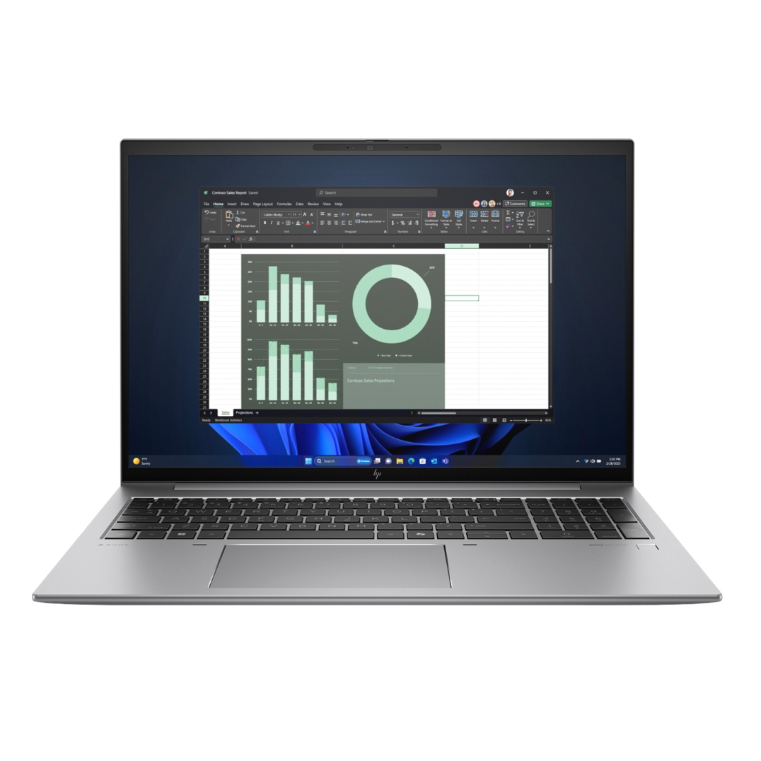 A silver laptop with a black keyboard displays a spreadsheet with graphs on the screen.