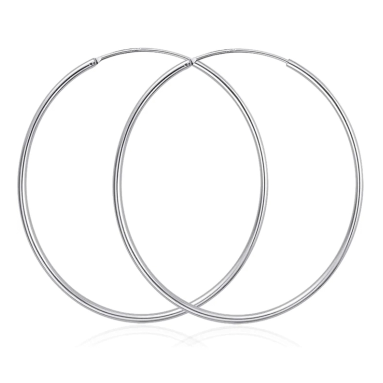 Two simple and sleek 65mm silver hoop earrings with a smooth finish and a thin, circular design for a minimalist and elegant look.