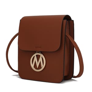 Brown leather crossbody bag with a flap closure and a gold circular emblem featuring the letter \“M\“ hanging on the front.