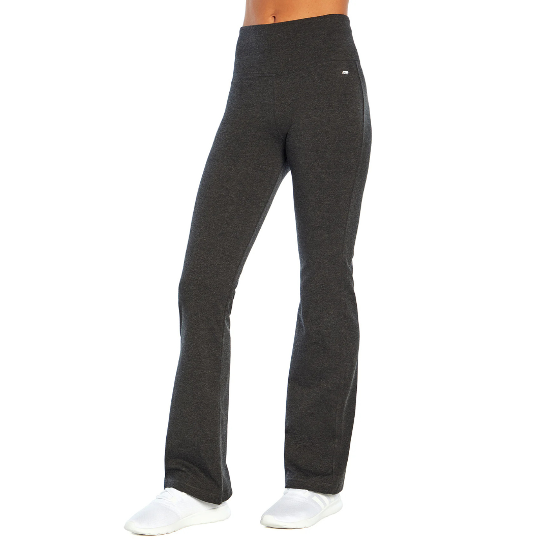 High-waisted, dark gray flared yoga pants paired with white slip-on shoes.