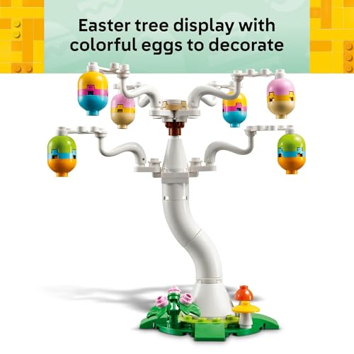 Easter-themed tree display with colorful eggs for decoration, featuring a curvy white trunk and branches on a grassy base with small floral and mushroom details.