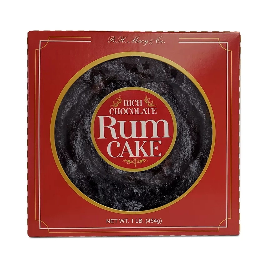 A round Rich Chocolate Rum Cake by R.H. Macy & Co. is packaged in a red box with a window revealing the textured top of the cake, labeled as weighing 1 lb (454g).