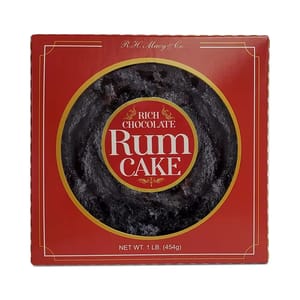 A round Rich Chocolate Rum Cake by R.H. Macy & Co. is packaged in a red box with a window revealing the textured top of the cake, labeled as weighing 1 lb (454g).