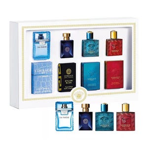 A collection of Versace cologne bottles in various colors and designs, showcased in a boxed set.