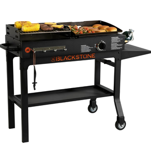 Outdoor gas griddle with food items cooking on the surface, featuring a flat top, storage shelf, and wheels.