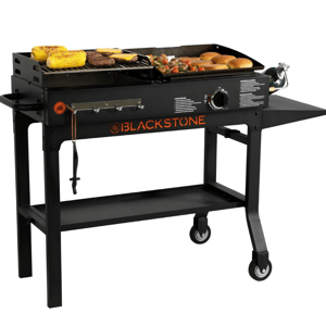 Outdoor gas griddle with food items cooking on the surface, featuring a flat top, storage shelf, and wheels.