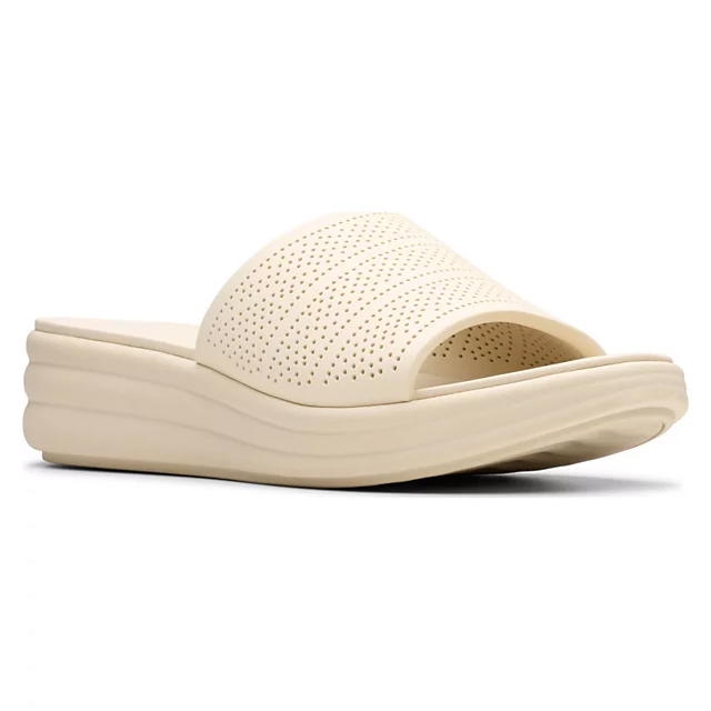 Cream-colored slide sandal with a textured, perforated strap and a thick, wavy sole for comfort.