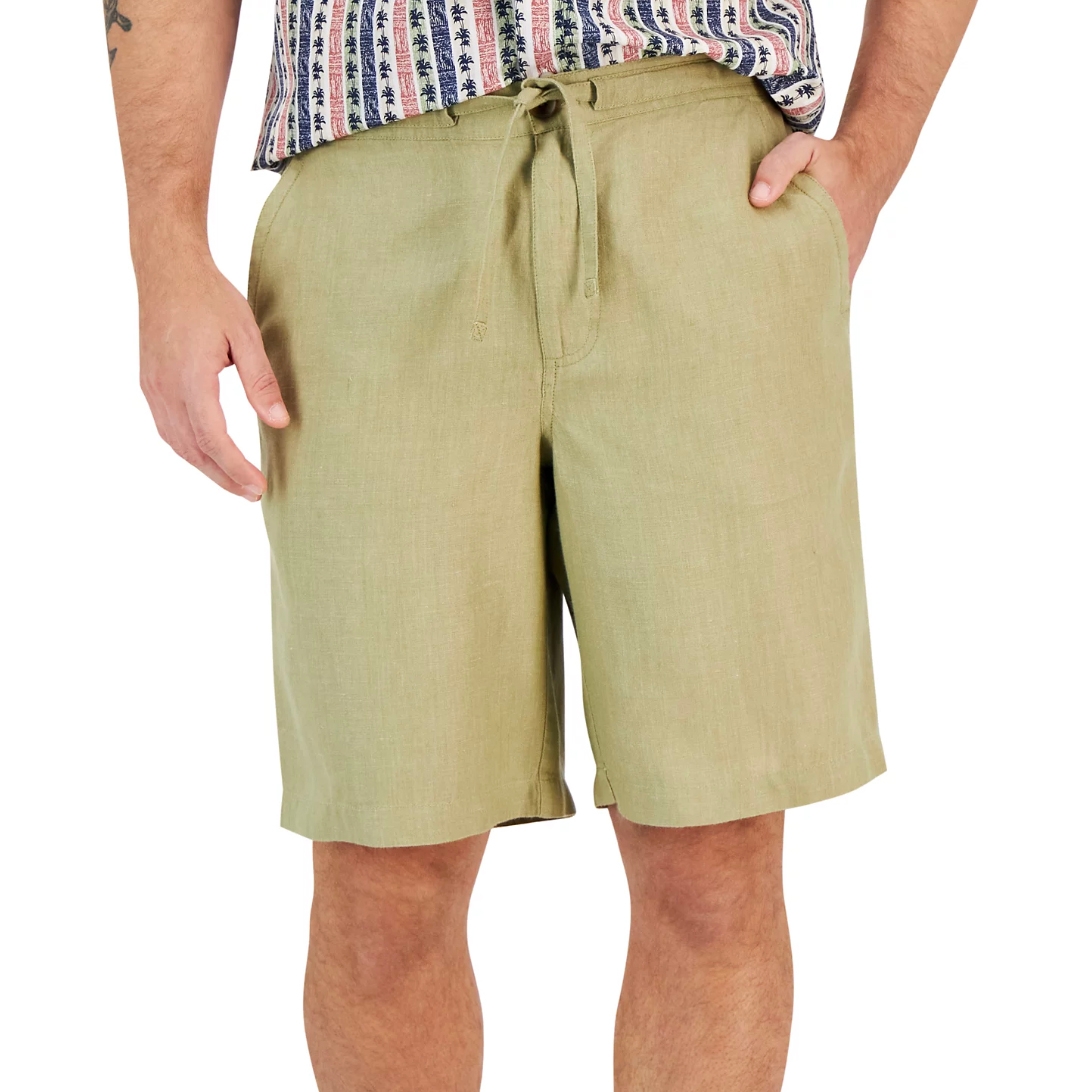 Light olive green linen shorts with side pockets and a drawstring waist, paired with a patterned shirt.