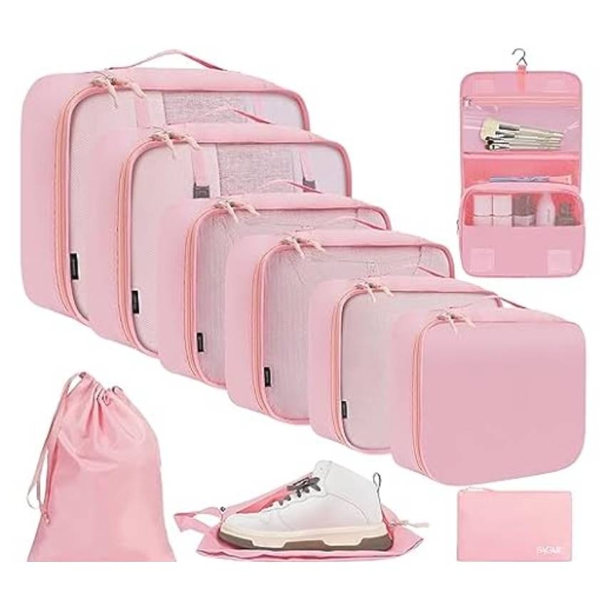 A set of pink travel packing cubes, including various sizes, a drawstring bag, a shoe bag, and a hanging toiletry organizer with compartments.