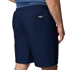 A man is wearing navy blue Columbia shorts with an elastic waistband and back pocket.