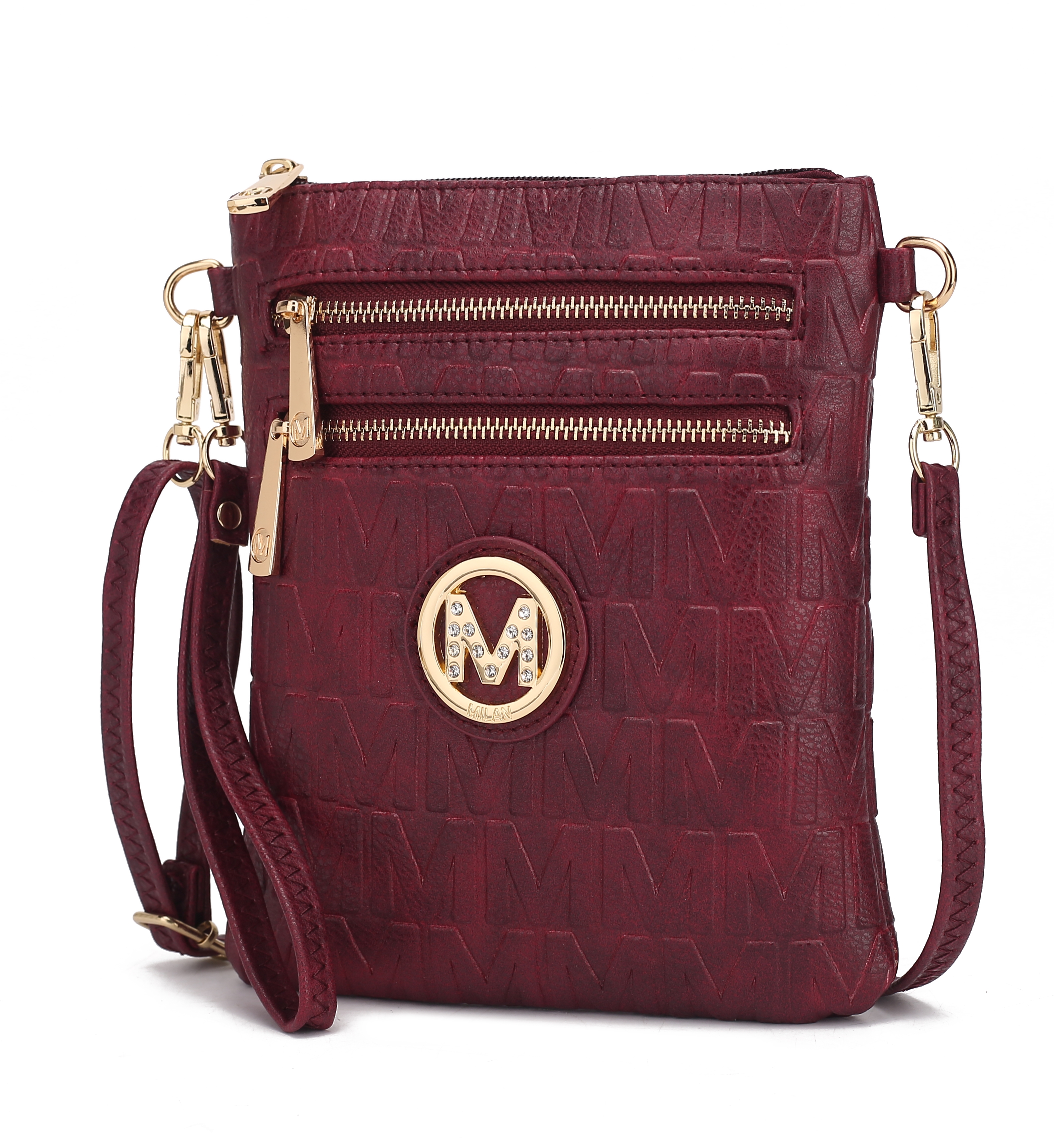 A maroon crossbody bag featuring an embossed \“M\“ pattern with gold accents, including two zip compartments and a circular emblem with rhinestones.