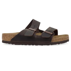A brown leather Birkenstock sandal featuring two adjustable straps with buckles and a cork footbed.
