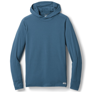 REI Men's Sahara Shade Hoodie is a lightweight, long-sleeve, blue hoodie equipped with a hood designed for sun protection and comfort. It features a small REI logo on the lower side.