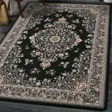 A dark green area rug with an intricate floral and medallion pattern, surrounded by a detailed border featuring similar floral motifs.