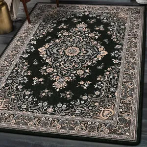 A dark green area rug with an intricate floral and medallion pattern, surrounded by a detailed border featuring similar floral motifs.