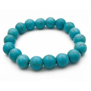 A turquoise bead bracelet with spherical beads strung together, featuring natural-looking vein patterns.