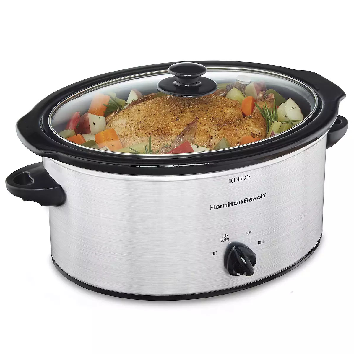 Hamilton Beach brand slow cooker with a clear lid, containing a seasoned roast and vegetables. Features include a dial with \“Keep Warm\“, \“Low\“, and \“High\“ settings.