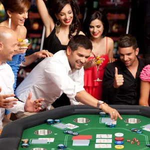 A group of people is engaging in a lively casino game at a table with cards and gambling chips.
