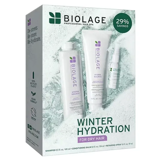 Biolage Winter Hydration set for dry hair includes Hydra Source shampoo (13.5 fl. oz./400 ml), conditioning balm (8.0 fl. oz./236 ml), and repairing spray (1.0 fl. oz./30 ml). Features 100% recycled plastic and vegan formula.