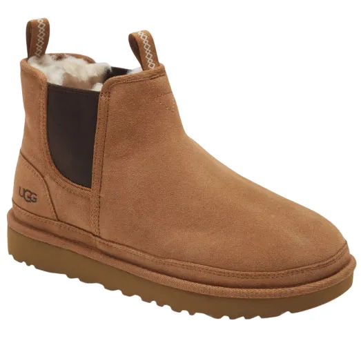 Tan suede ankle boot with shearling lining, elastic side panels, and a pull tab, featuring a branded logo on the heel.