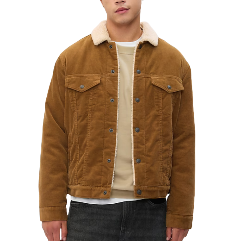 Brown corduroy jacket with a sherpa-lined collar, button front closure, dual chest pockets with flaps, and side pockets. Worn over a light beige sweater and paired with dark jeans.