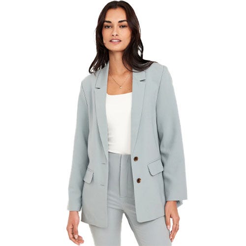 A woman wearing a light blue blazer with a relaxed fit.
