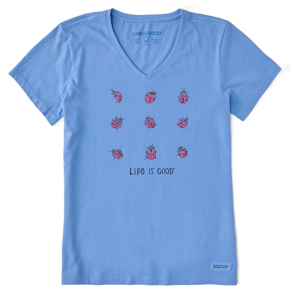 Light blue V-neck T-shirt with a \“Life is Good\“ logo, featuring a grid of nine small, pink ladybugs printed on the front.