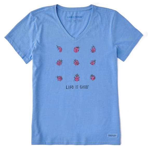 Light blue V-neck T-shirt with a \“Life is Good\“ logo, featuring a grid of nine small, pink ladybugs printed on the front.